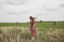 woman standing in a field 