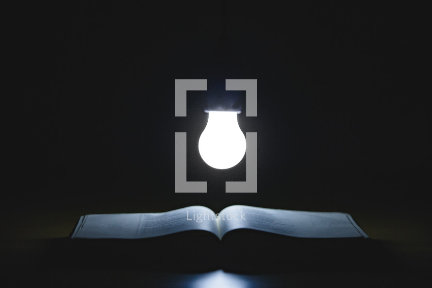  lightbulb over the pages of a Bible 