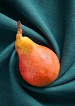 Abstract of One Pear on Swirled Cloth Background