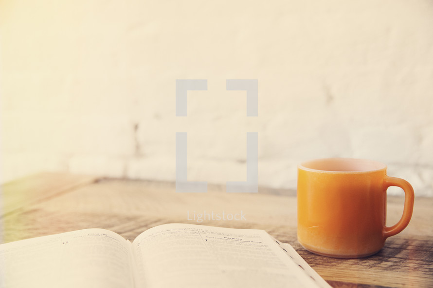 an open Bible and coffee mug 