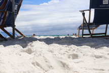 beach chairs in white sand 