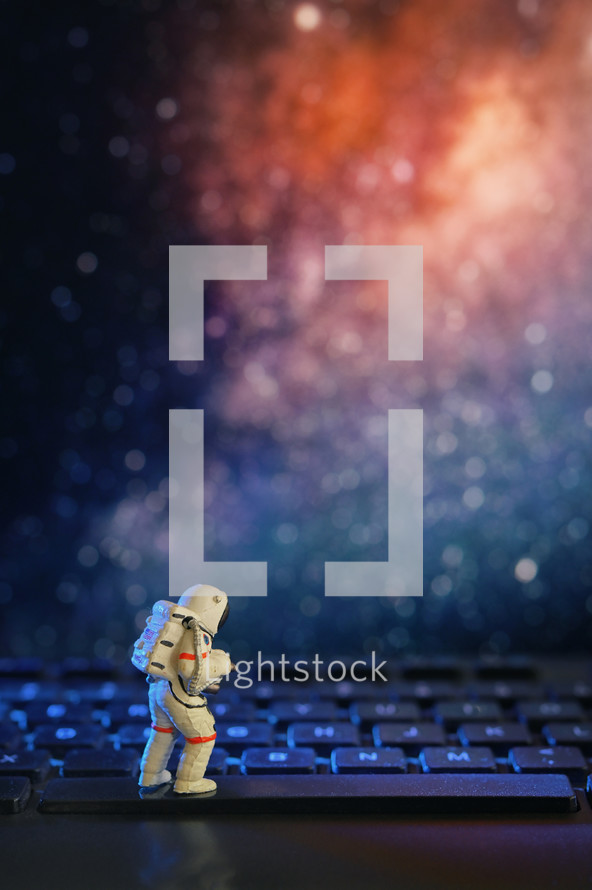 Conceptual astronaut on space. Sitting on space key