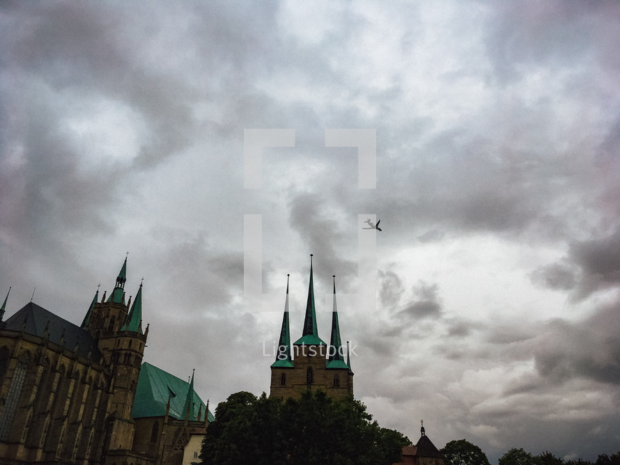 plane flying over a cathedral 