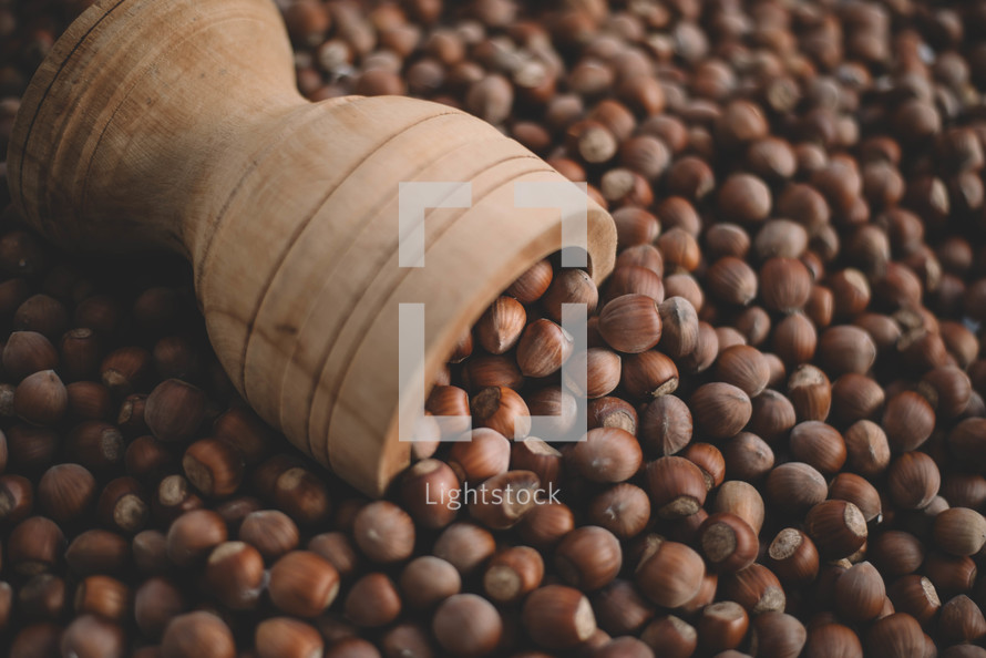 Hazelnuts in a wooden bowl on rustic background