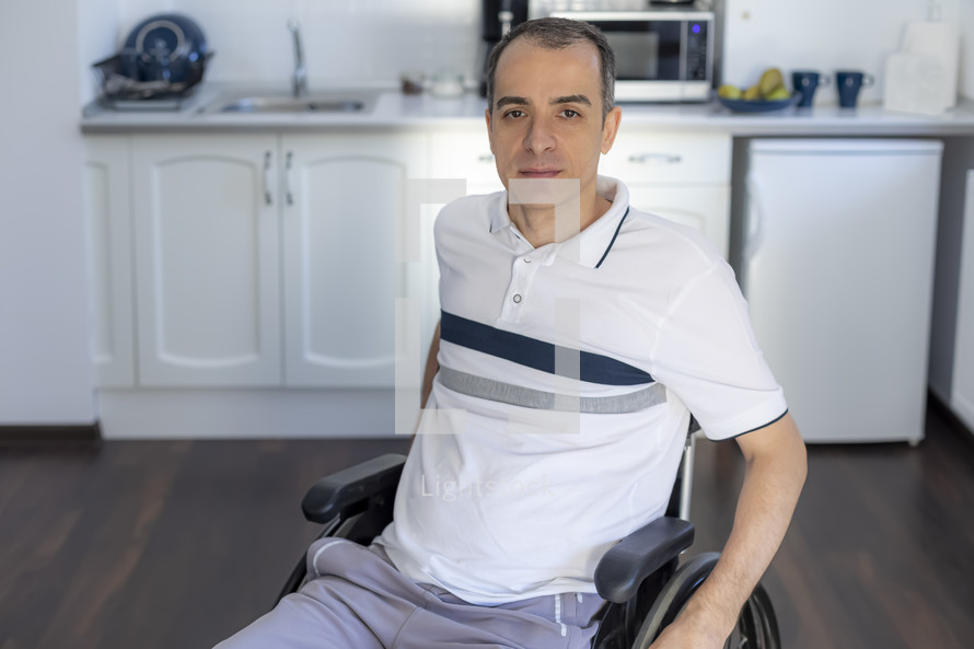 a man in a wheelchair in his kitchen 
