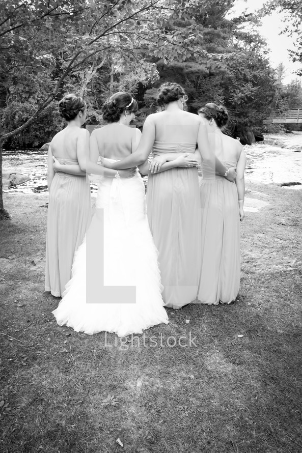 bride and bridesmaids with backs to the camera 
