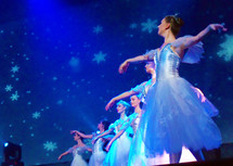 A group of six ballet dancers performing the nutcracker ballet from the Ukraine at a church during Christmas time. 