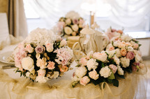 flower bouquets on a table at a wedding reception 