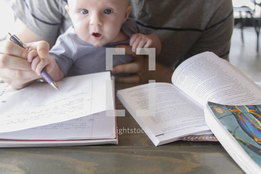 a graduate student studying with a baby 