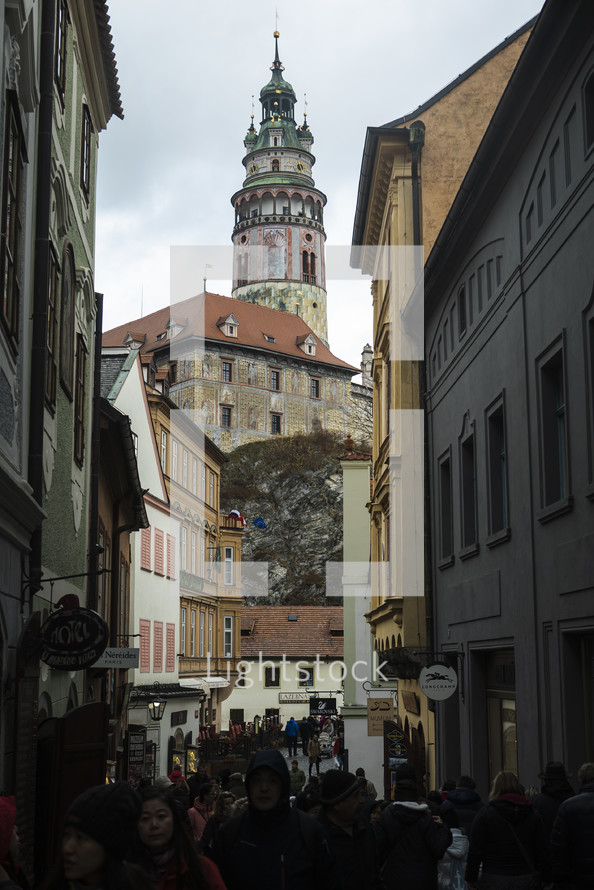 people walking on a street and view of a tower 