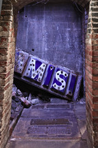 old rusty sign in alleyway