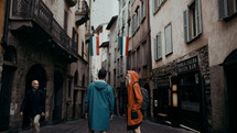 a couple standing on a narrow Italian street 