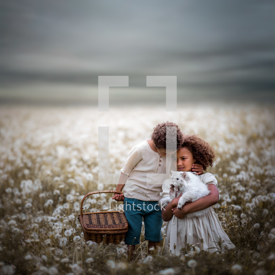 siblings hugging in a field 