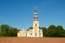 plowed field and church 