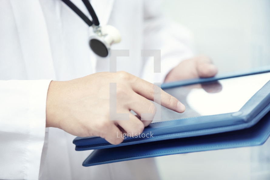 a doctor holding a tablet 
