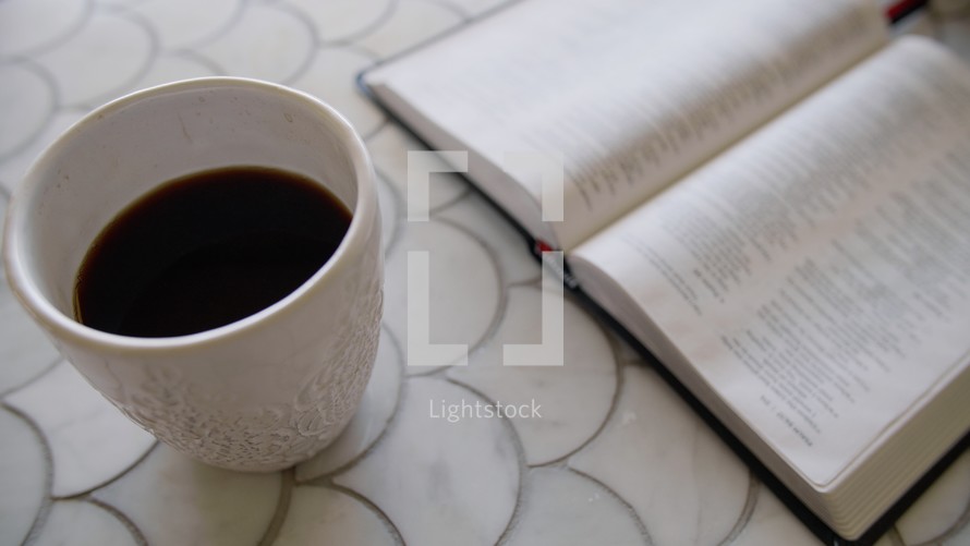 coffee cup and opened Bible