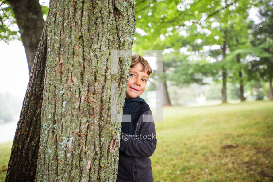 hiding behind a tree 