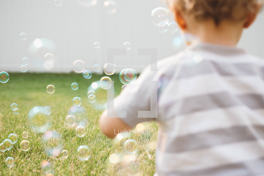 toddler playing with bubbles 