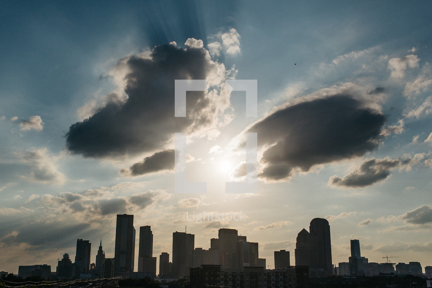 sunburst over a city skyline 