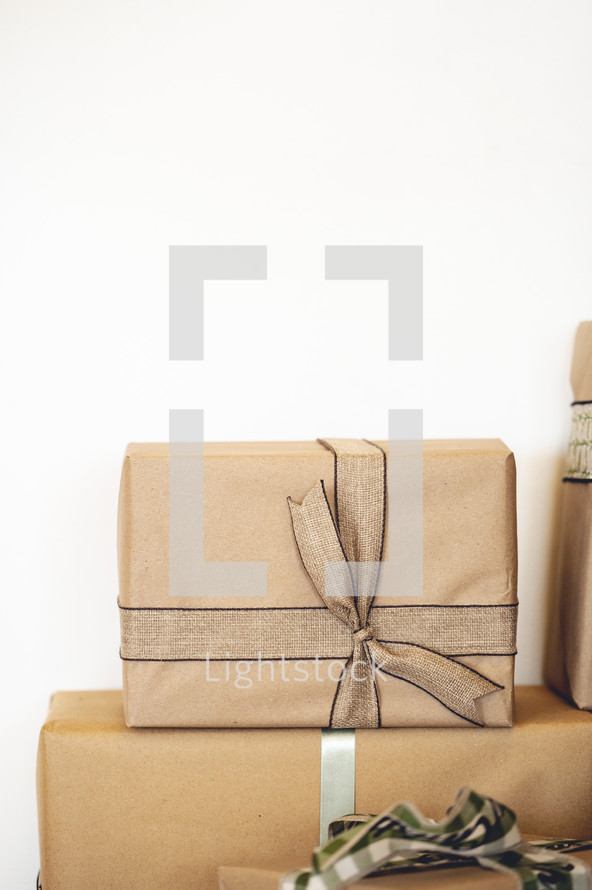 Stacked brown paper wrapped gifts 