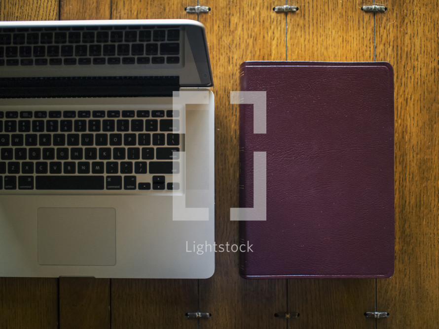 a laptop computer and a Bible 