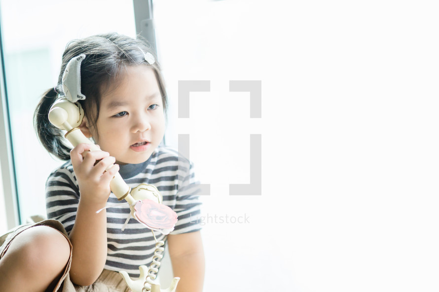 girl talking on a vintage telephone 
