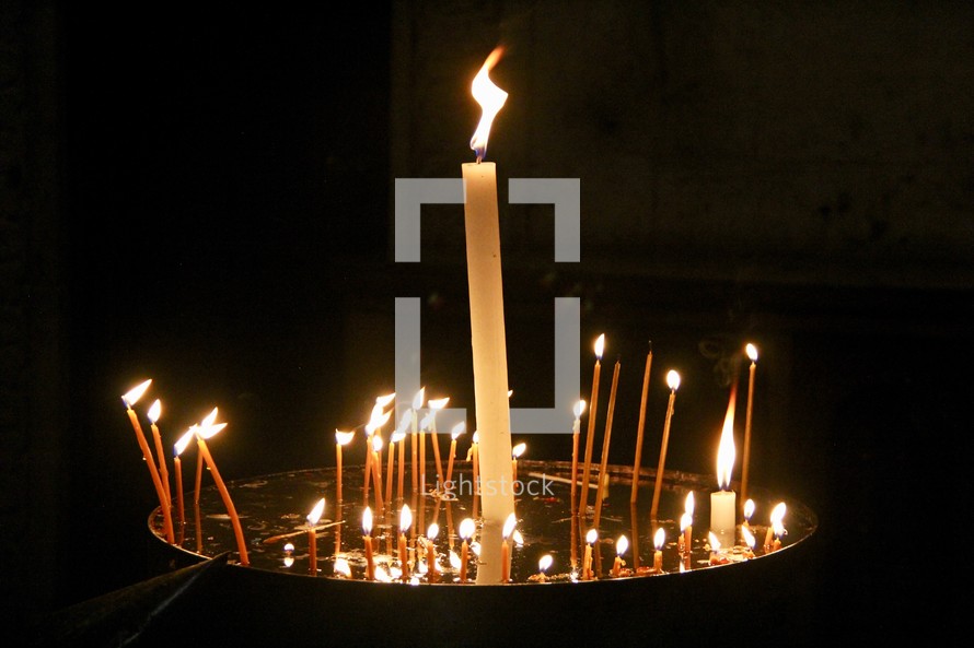 Votive, offering or prayer candles alight in the Church of the Sepulcher, Jerusalem, Israel