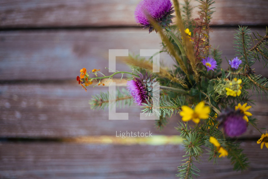 wildflowers in a vase on picnic table 