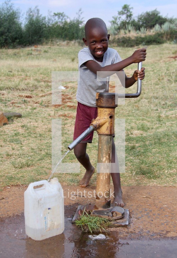 a boy pouring a jug of water 