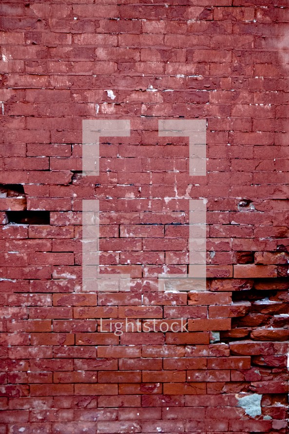broken bricks in a red brick wall