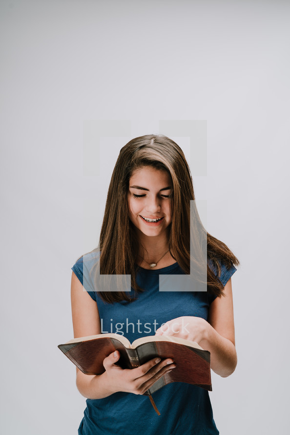 a teen girl reading a Bible 