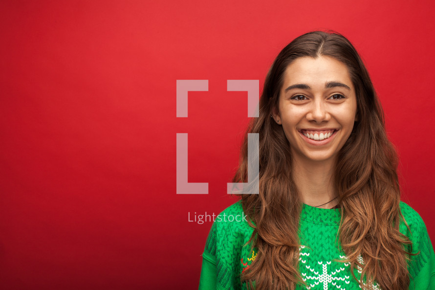 a headshot of a smiling woman in a Christmas shirt 