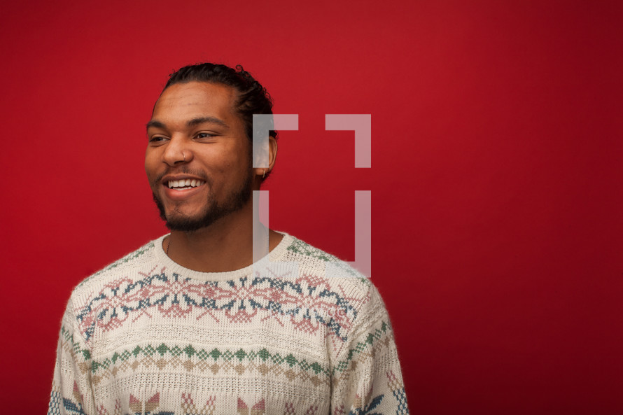 headshot of a man in a Christmas sweater 