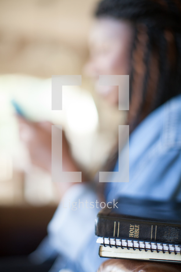 distraction - woman on a phone and Bible 