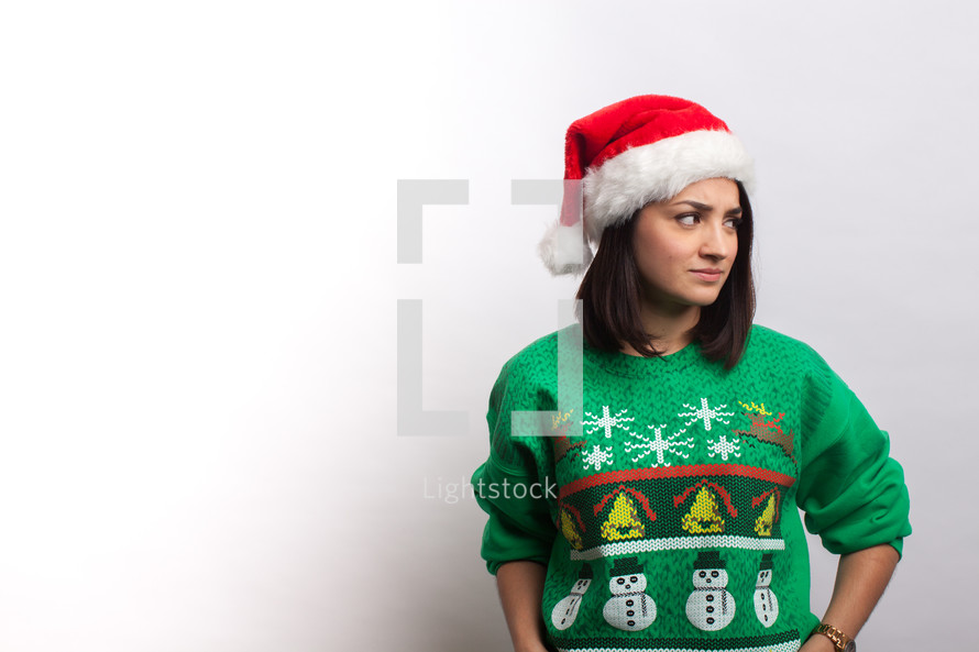woman in an ugly Christmas sweater and santa hat 