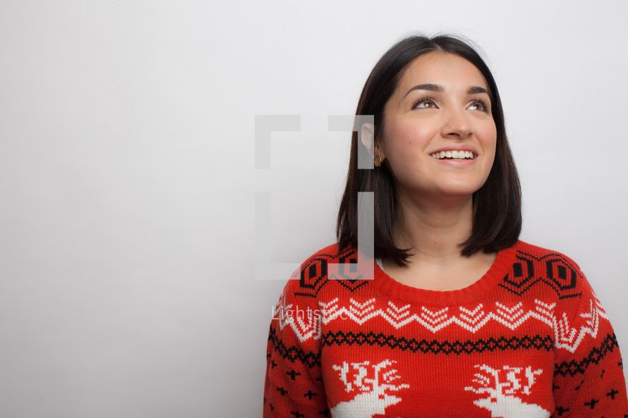Latino woman in an ugly Christmas sweater 