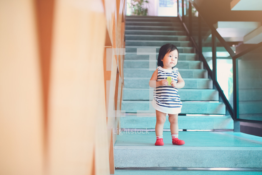 toddler girl standing on stairs 