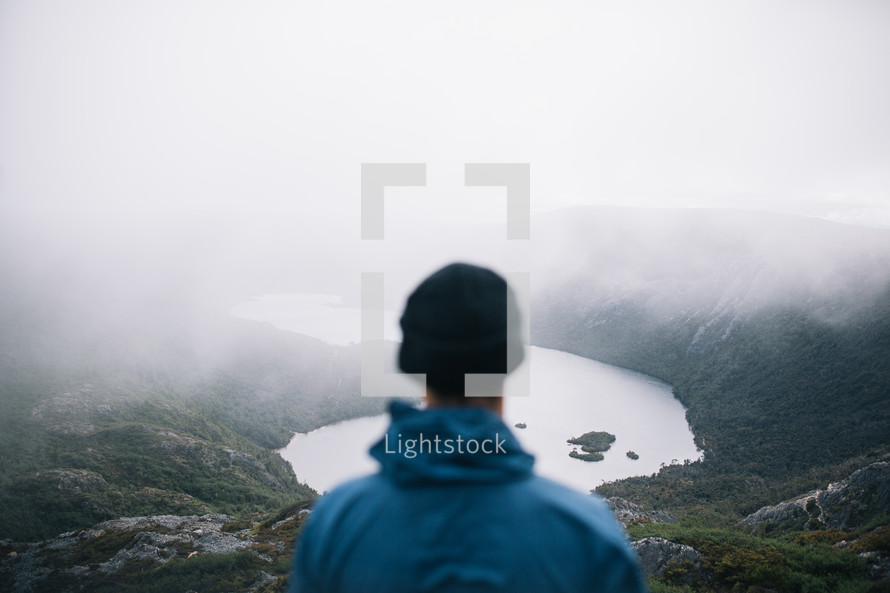 a man with a view of a lake in a valley in Tasmania 