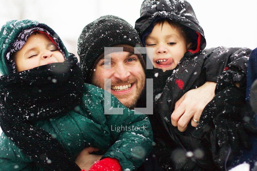 Dad and kids playing in the snow