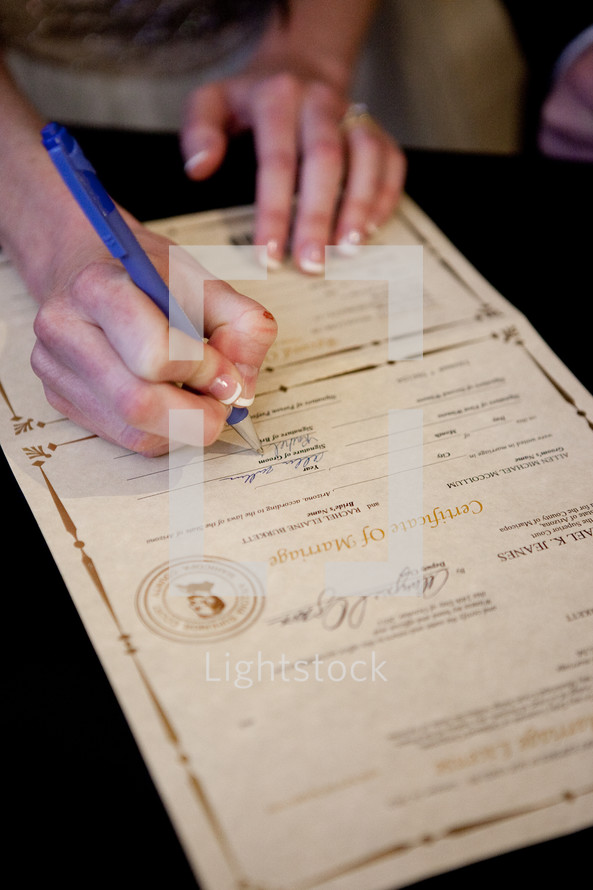 Woman signing a legal document
