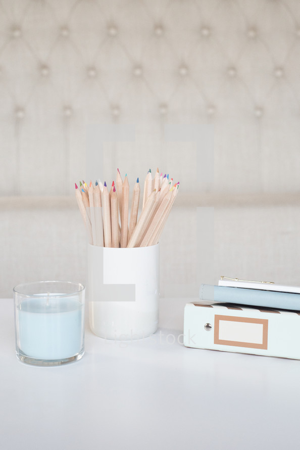 candle, cup, colored pencils, journal, notebook 