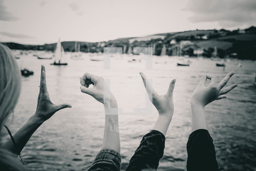 word love with hands and boats in water 