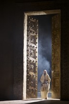 man entering temple doors 