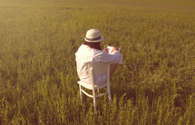 a woman sketching in a field 