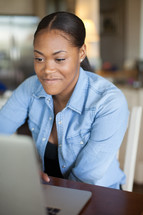 African-American woman looking at a computer screen 