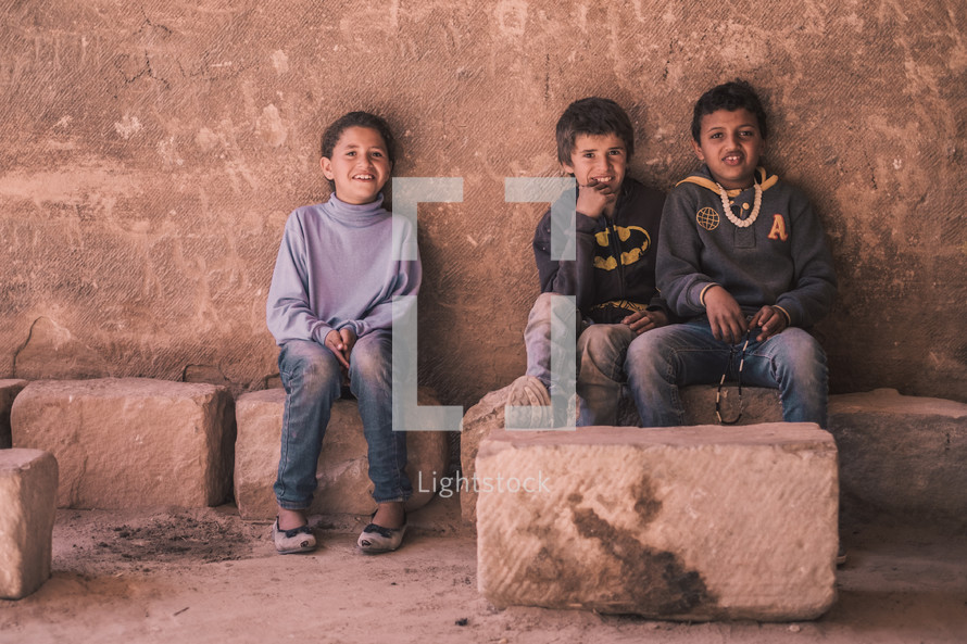 children sitting in an old historic building 