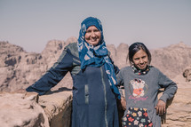 mother and daughter standing in a desert 