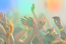 Defocused image of close-up with peoples hands on running marathon, people covered with colored powder.