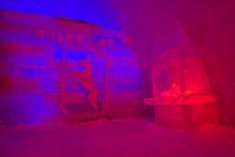 Balea Lake ice hotel entrance with blue and red lights. 