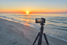 filming Sunrise over the sea coast.
